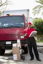 Photo of a courier delivering to someone in Gloucester on a sunny day.