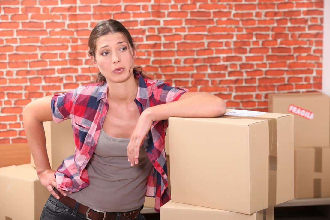 Woman resting during a house removal in Gloucester.