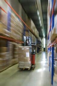 This is a picture of a fork lift truck moving boxes into storage.