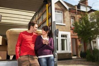 Photo of couple waiting for the keys before moving into their new home.